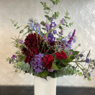 Red and blue hues in a vase - This is an absolutely stunning bouquet of reds, blues and purple hues in a vase so you don’t have to worry about one!