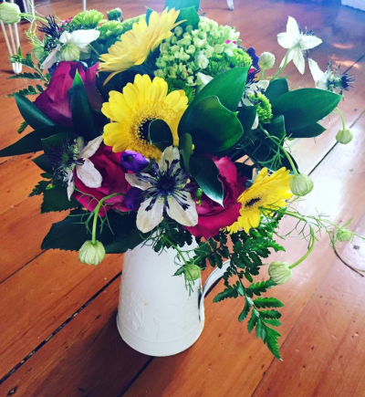 Sunshine Country Jug - A bright and cheerful arrangement filled with vibrant colours and fresh greenery, beautifully presented in a decorative jug. A lovely gift designed to bring instant colour and happiness to any room.