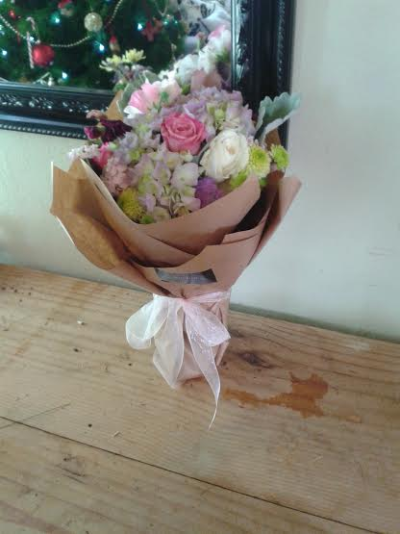 Pretty Country Posy - A soft and delicate hand-tied posy in beautiful pastel shades. Stylishly wrapped with a pretty finishing bow, this charming design is perfect for birthdays, congratulations, thank-yous or just because.