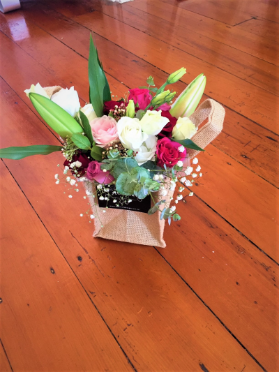Rustic Delight - A pretty arrangement filled with a gorgeous mix of pink, white and deeper berry shades. Presented in a rustic hessian-style bag, this cheerful design is perfect for birthdays, thank-yous and celebrations.